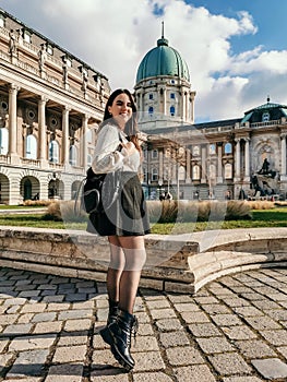Vertical of an attractive young woman standing in the courtyard of Buda royal palace in Budapest