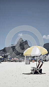 Vertical Beach umbrella standing on the Ipanema beach during very hot summer and sunny day in Rio de Janeiro