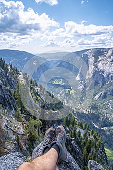 Vertical beautiful shot a man sitting in the Yosemite National Park Yosemite in the USA