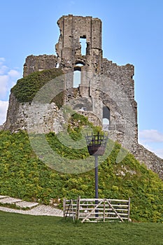 Vertical beautiful shot of the ruins of Corfe Castle under the blue sky