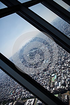 Vertical birds-eye view of a city from the skyscraper glass window