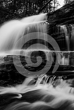 Vertical black and white image of Onondaga Falls, in Ricketts Glen State Park