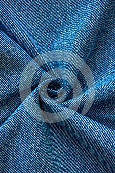 Vertical Blue colored folded and crumple denim cloth texture with copy space