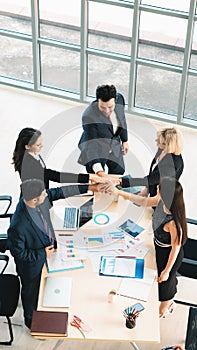 Vertical business background of group of business people having hand touch together to show teamwork and unity after business