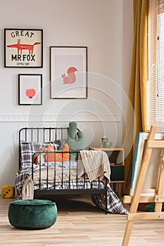 Vertical capture of genderless cozy bedroom in elegant tenement house photo