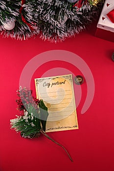 Vertical christmas photo with postcard and decorations on red background