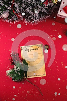 Vertical christmas photo with postcard and snow and decorations on red background