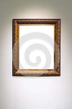 Vertical classic golden picture frame on gray wall