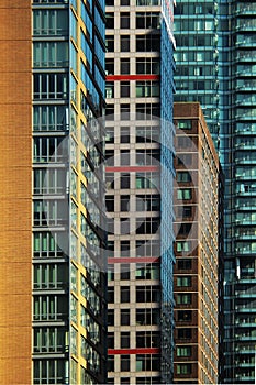 Vertical close up architectural abstract of a row of colorful office skyscraper buildings in Midtown, Manhattan, New York