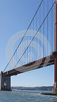 Vertical section of the suspension and cropped view of south tower of the iconic Golden Gate Bridge, San Francisco, California, US