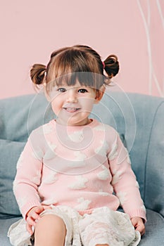 Vertical close up indoor portrait of cute happy baby girl