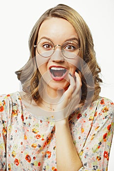 Vertical close-up portrait of young woman with vivid emotion surprise, opened mouth, eyes wide open, expresses surprise