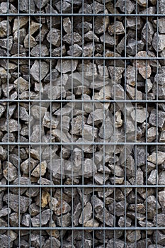 Vertical close-up shot of a cade filled with small rocks photo