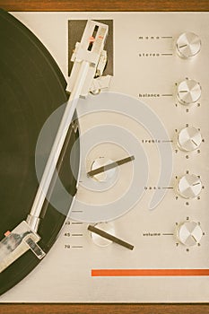 Vertical close up of a vintage seventies turntable with spinning record