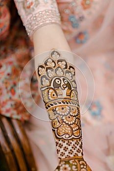 Vertical closeup of a beautiful Bridal henna, mehndi on the hand of an Indian bride