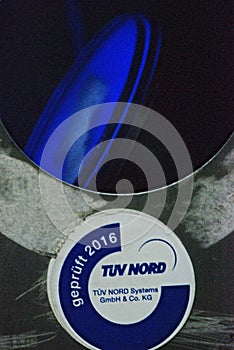 Vertical closeup of a broken escalator column with TUEV Nord test seal on the A40 in Essen, Germany