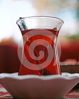 Vertical closeup of a cup of Turkish tea with a spoon in it