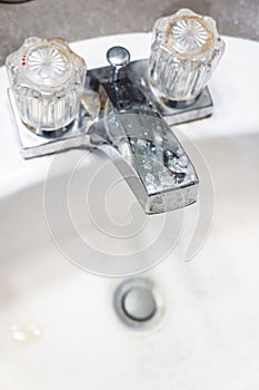 Vertical closeup of the faucet on the sink