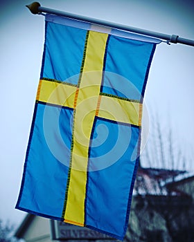 Vertical closeup of the flag of Sweden.