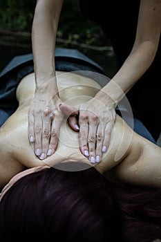Vertical closeup of a professional relaxing back massage