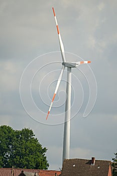 Vertical closeup of a red and white windmills