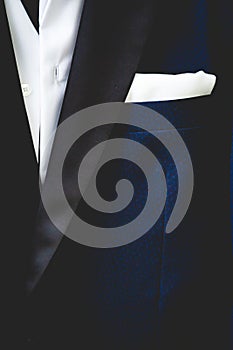 Vertical closeup shot of a blue man suit with a white shirt and pocket square