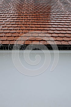 Vertical closeup shot of a brown roof under the heavy rain