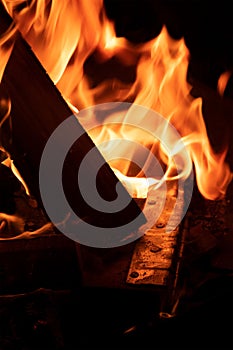 Vertical closeup shot of a campfire litten with wood