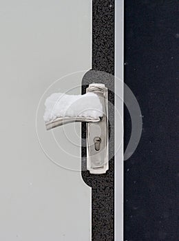 Vertical closeup shot of a door with snow on the door handle