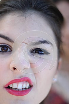 Vertical closeup shot of a female with a funny expression and a scrunched nose