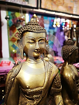 Vertical closeup shot of Gautama Buddha statue on a blurred background