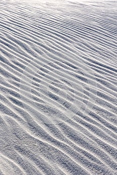 Vertical closeup shot of gypsum sand dunes at White Sands National Park, New Mexico