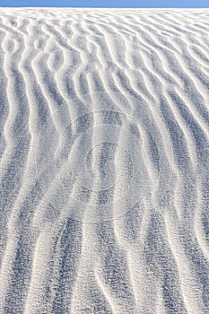 Vertical closeup shot of gypsum sand dunes at White Sands National Park, New Mexico