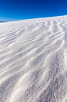 Vertical closeup shot of gypsum sand dunes at White Sands National Park, New Mexico