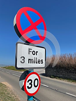 Vertical closeup shot of No stopping UK road sign with a 30mph limit