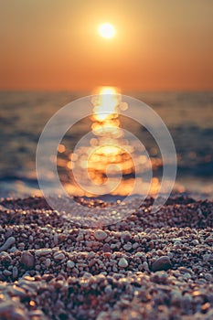 Vertical closeup shot of pebble stones on the beach at sunset