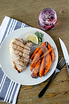 Vertical closeup shot of a plate of Chicken Breast with Sweet Potato Fries