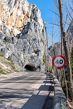 Vertical closeup shot of a road in the mountains with a road sign \