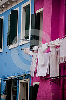 Vertical closeup shot of white laundry hanging to dry under the sky