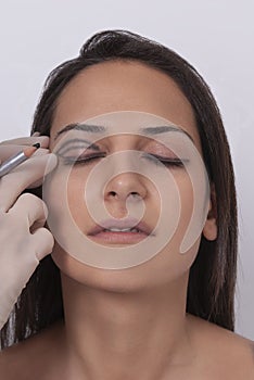 Vertical closeup shot of a woman preparing her face for a plastic surgery  procedure  professional