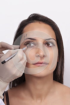 Vertical closeup shot of a woman preparing her face for a plastic surgery  procedure  professional