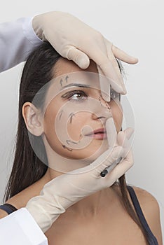 Vertical closeup shot of a woman preparing her face for a plastic surgery  procedure  professional