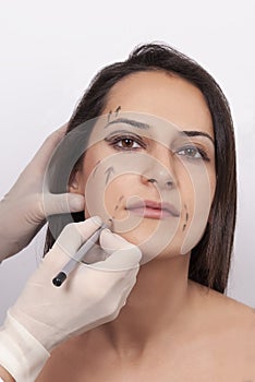 Vertical closeup shot of a woman preparing her face for a plastic surgery  procedure  professional