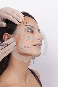 Vertical closeup shot of a woman preparing her face for a plastic surgery  procedure  professional