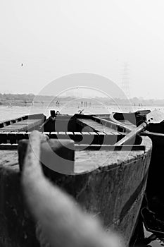 Vertical closeup shot of a wooden boat and an oar, black and white photography