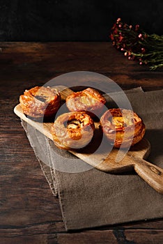 Vertical closeup of Vol-au-vent puff pastry on a cutting board on a wooden table