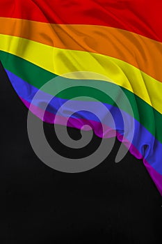 Vertical color LGBT rainbow flag, Pride flag, beautiful silk, black blank, concept of tourism, economy, politics, emigration,