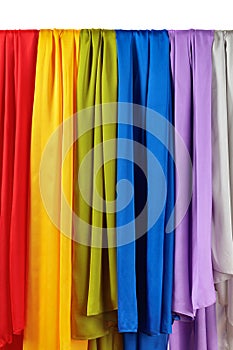 Vertical colorful satin curtains isolated on white