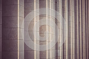 Vertical columns of the facade of a modern building as background