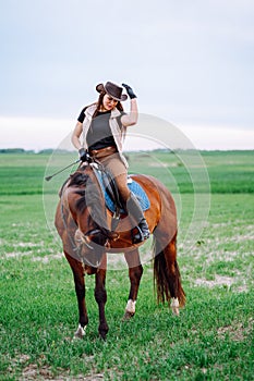 Vertical confident tone horse woman hat with riding crop, look down, holding harness, whip, training. Horseback riding,